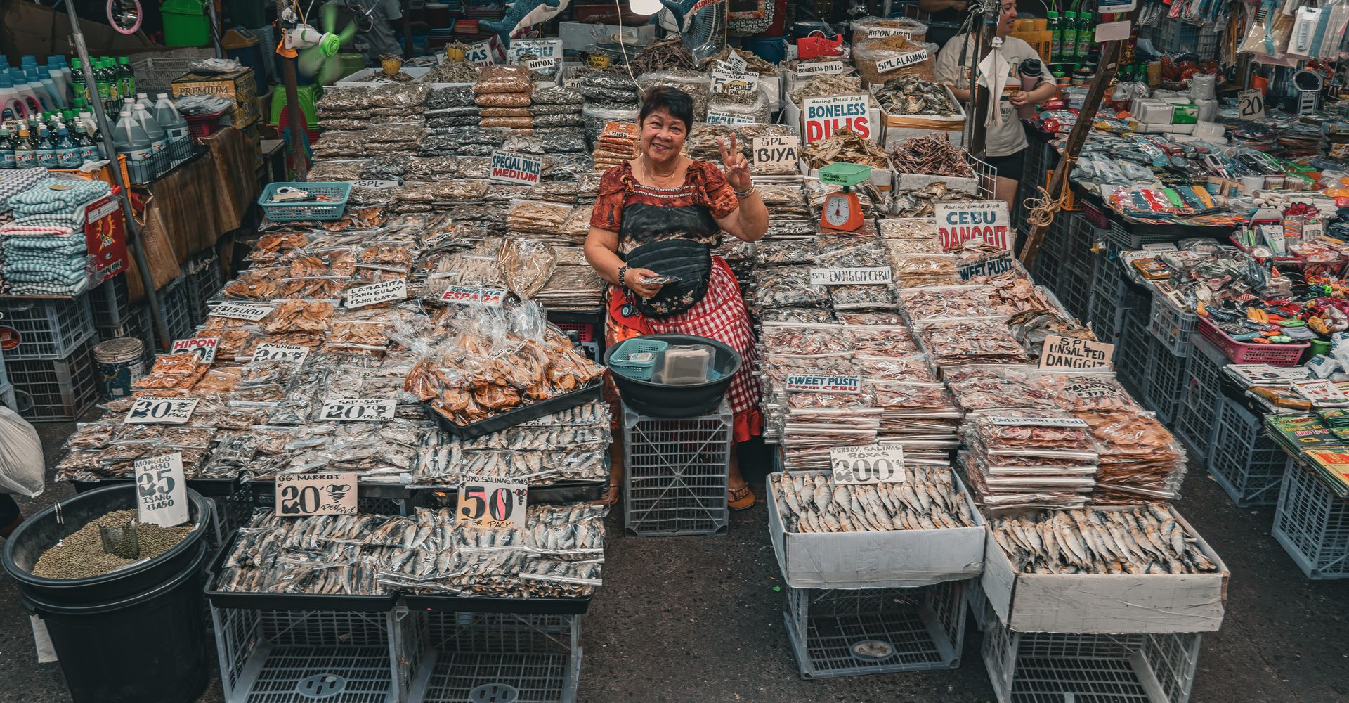 A smiling vendor at her market stall in the Philippines